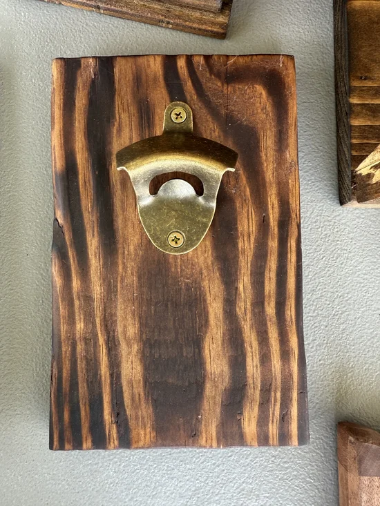 Brass Finish Wall-Mounted Bottle Opener on Dark Wood