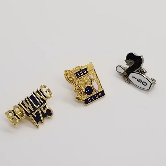 trio of bowling accomplishment pins