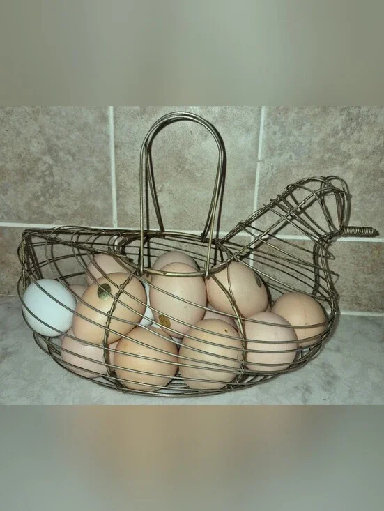 Vintage-style wire egg basket is shaped like a hen