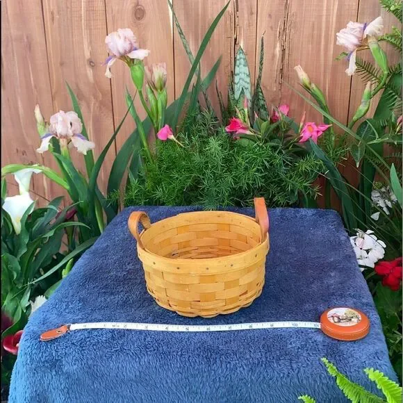 Circular basket with plastic insert and leather handles by Longaberger
