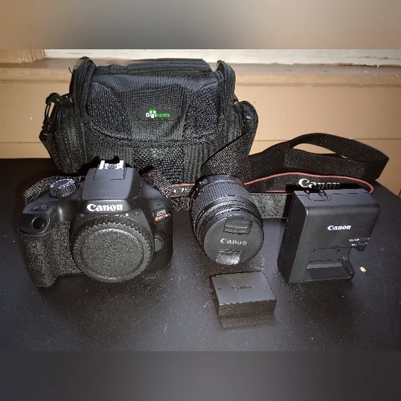 Digital Camera EOS Rebel T100, Zoom Lens EF-518-55mm, Strap, Battery & Charger.