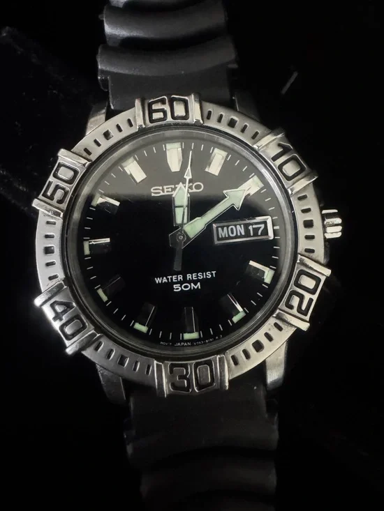 Seiko Black Dial Watch with Silver Bezel