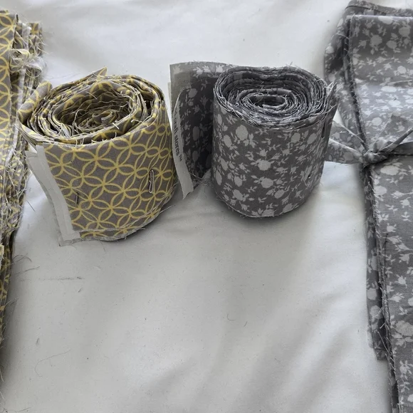 Jellyrolls. Yellow and Gray Fabric Rolls. 2.5