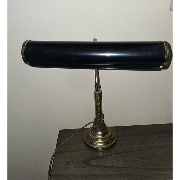Vintage brass tone desk lamp with elegant scroll arm and classic piano light