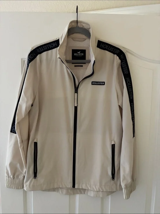 Hollister Men's Cream Track Jacket with Black Trim and Logo Tape