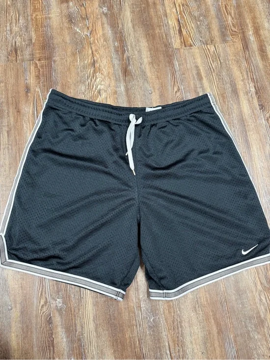 Vintage y2k Nike black shorts with white stripes on sides and hem, size S