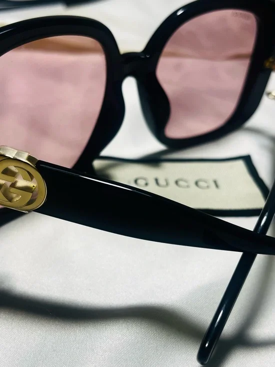 Gucci Black Frame Sunglasses with Pink Lenses and Gold Logo Accent
