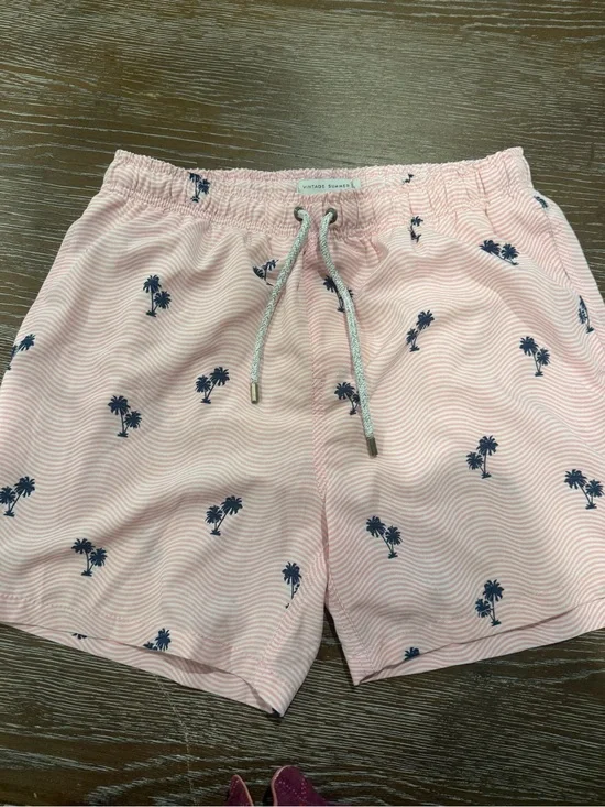Pink swim trunks with palm trees
