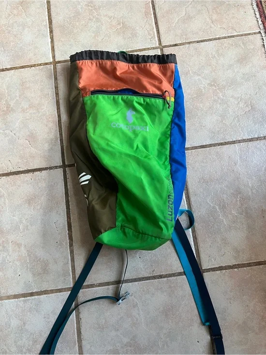 cotopaxi multicolor interior daypack with blue, green, orange accents