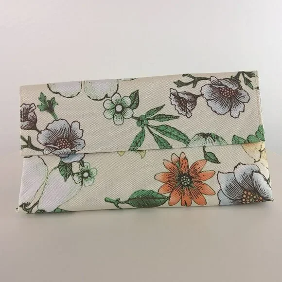 Clinique cream floral print fold over makeup / jewelry bag.