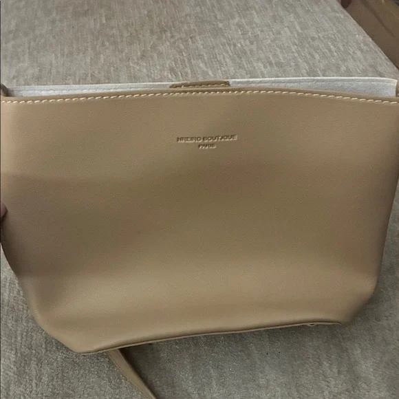 Tan purse‎ with sleek design and smooth finish.