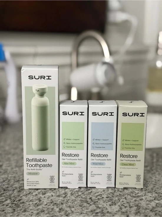 Suri refillable toothpaste dispenser with 3 refill flavors