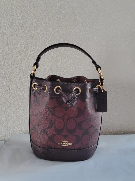 NWOT Coach burgundy Dempsey bucket bag with adjustable drawstring,