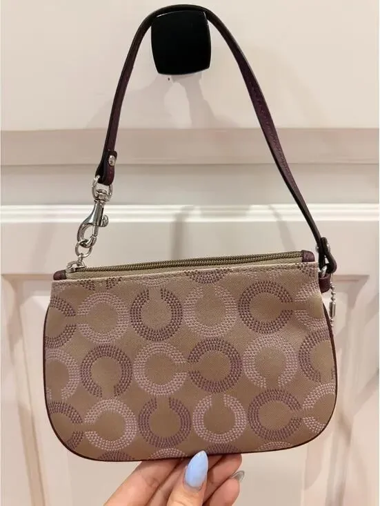 Coach Wristlet with Repeating Purple C Logo Pattern