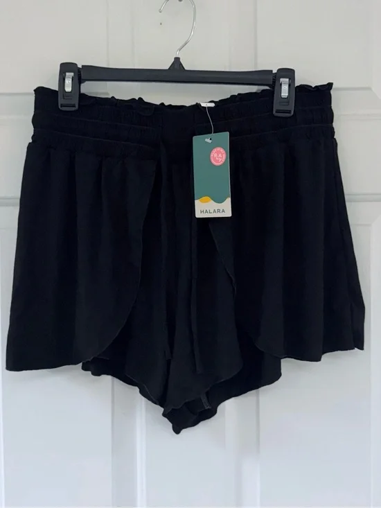 New Halara stretchy black shorts with tie at waist and flowy panels on the front