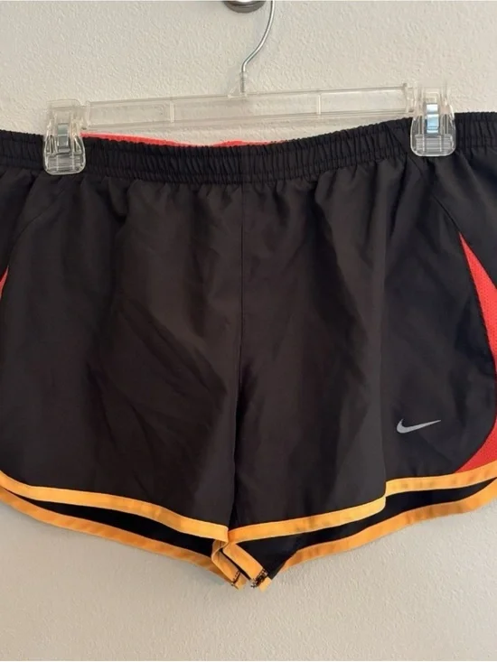 Nike Women’s Black Athletic Shorts with Orange Trim and Red Panels
