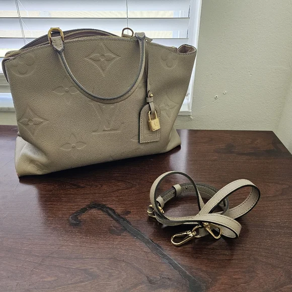 This is a Louis Vuitton Grand Palais bag in Tourterelle Empreinte leather
