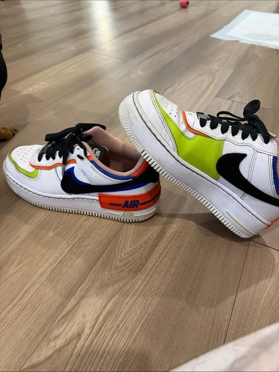 Nike White Low-Top Sneakers with Black Swoosh and Neon Green & Orange Accents