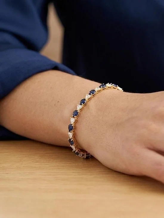 Gold Bracelet with Deep Blue Gemstone Accents