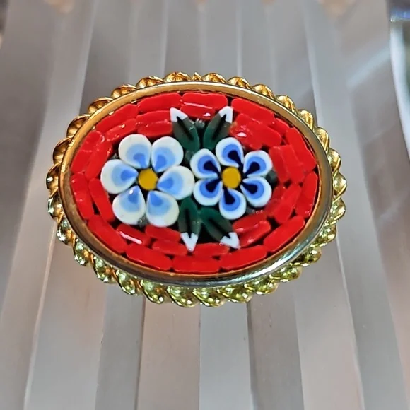 Vintage millefiori micro mosaic flowers pin brooch set in a gold edged frame.