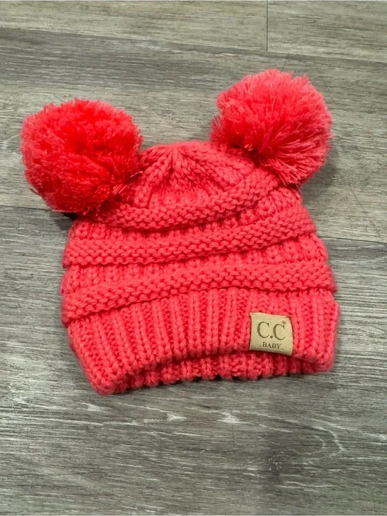 C.C. brand baby beanie w/ coral-colored cable knit design w/ two plush pom poms