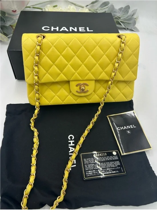 CHANEL CLASSIC QUILTED double flap bag . Yellow with gold hardware .