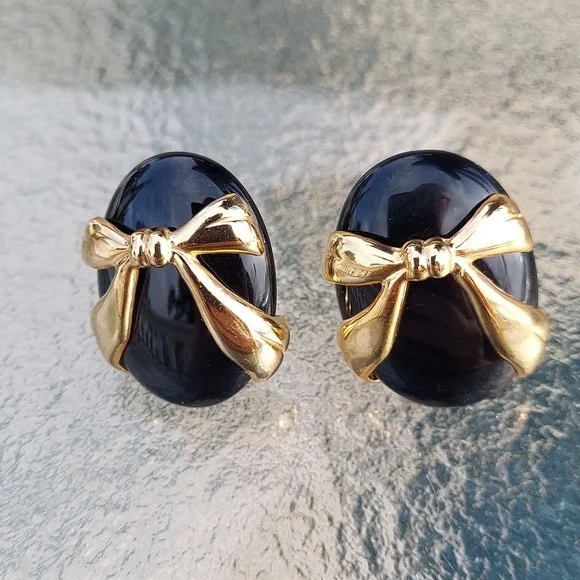 Vintage gold-tone ribbon bow on black oval clip on earrings