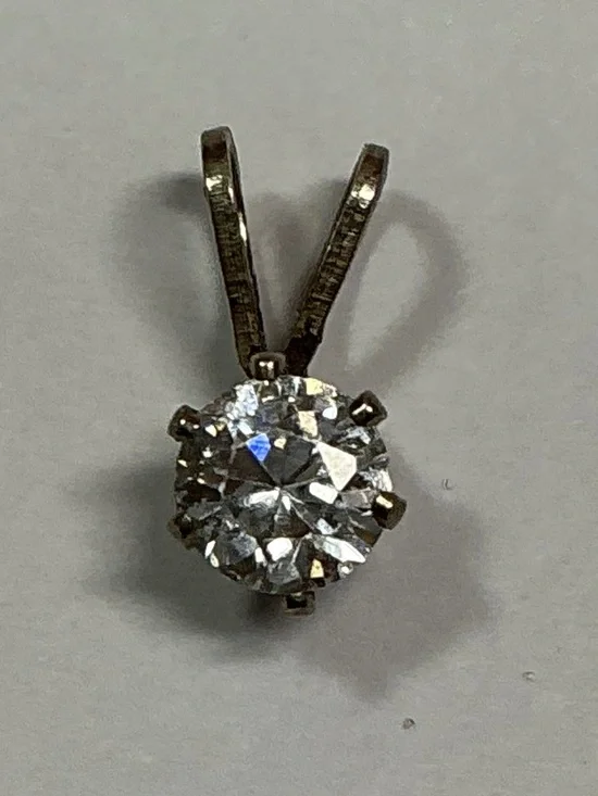 Sterling Silver Petite Pendant with a clear stone. 1/2 inches long
