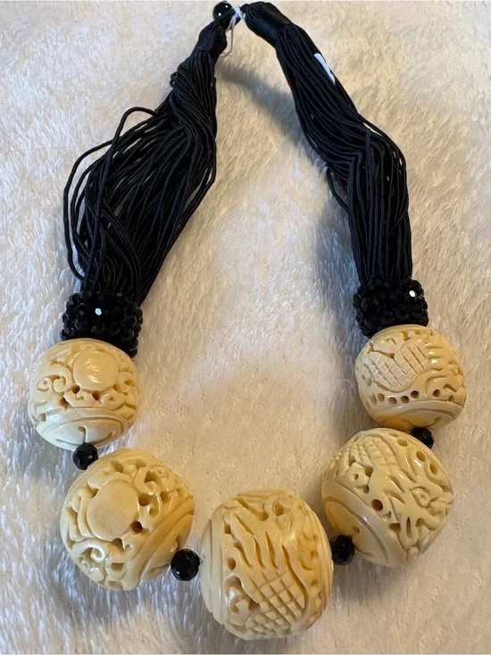 Carved Ivory-Tone Bead Statement Necklace with Black Tassels
