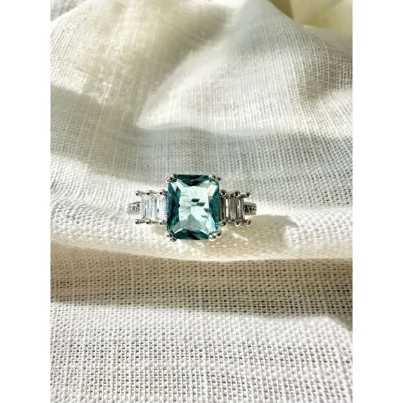 Light blue elongated radiant cut ring