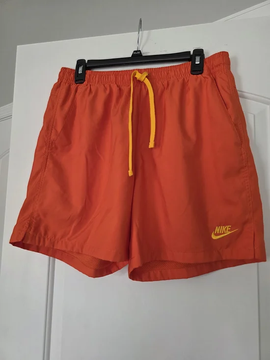 Nike Men's Orange Athletic Shorts with Yellow Drawstring and Logo