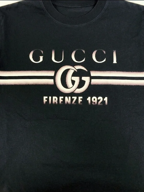 Gucci Black Tee with Faded White Logo and Stripes.