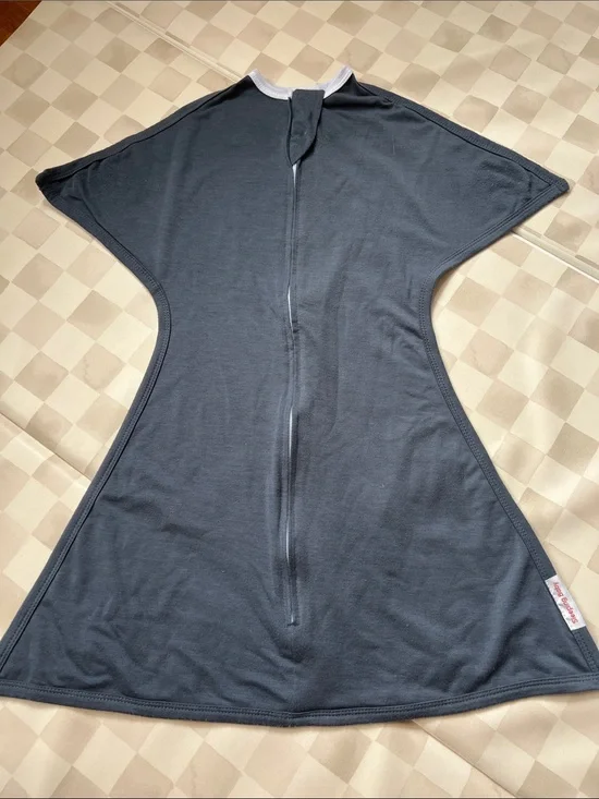 1 of 2. Sleeping baby, zipadee zip swaddle, size small