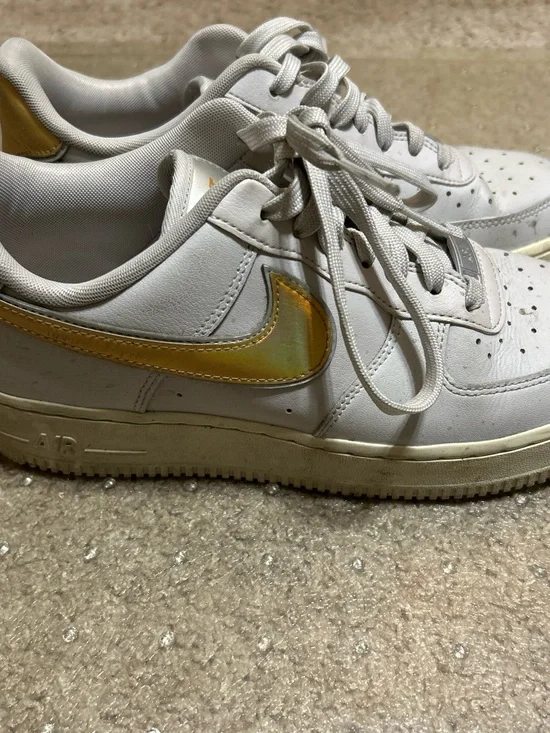 Nike White Athletic Shoes with Gold Swoosh