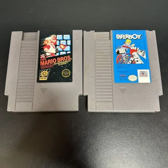 NES PAPERBOY TOY VIDEO GAME AND  SUPER MARIO BROS CARTRIDGE.