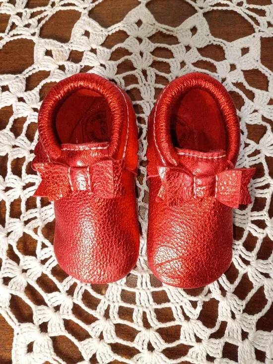 Freshly picked ruby red baby mocassins with bow and ruffles size 5