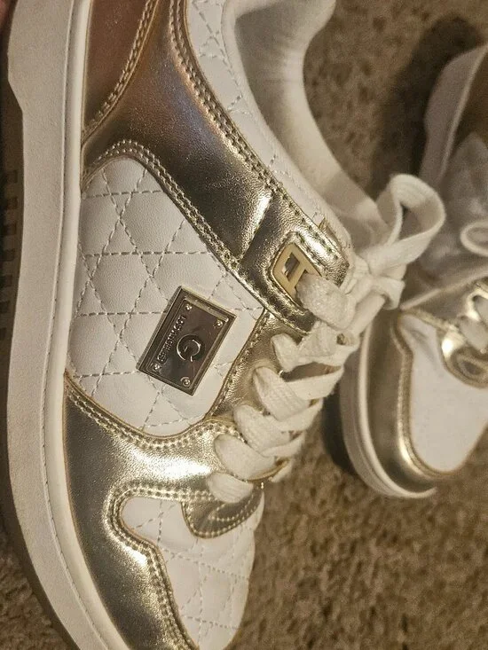 women's Guess quilted fashion sneakers in white and gold.
