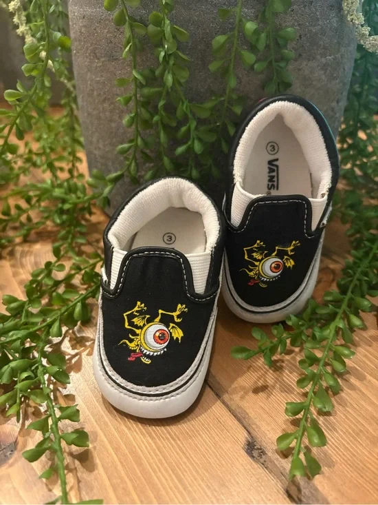 Vans Kids Black Slip-On Sneakers with Yellow and Red Monster Eyeball