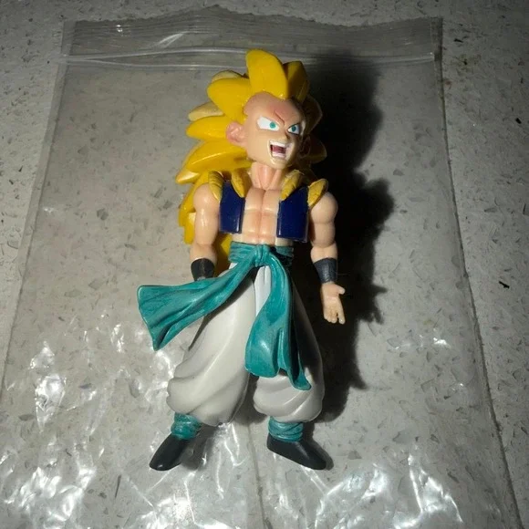 Dragon Ball Z Goku Super Saiyan 3 action figure with yellow spiky hair, blue