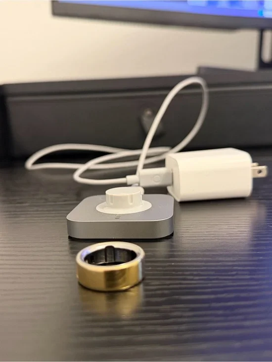 Oura Silver Charging Base with White Magnetic Puck and Gold Oura Ring 4