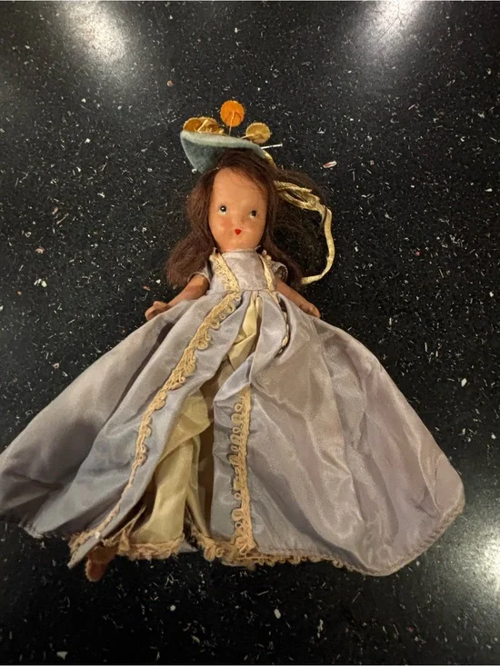 Vintage NaPorcelain Doll in Pale blue and Gold Gown labeled “Storybook doll