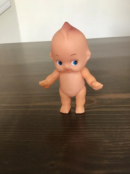 Vintage unmarked 6-inch hard plastic Kewpie doll from the mid-century era