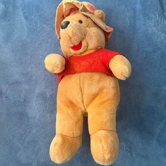 Winnie the Pooh plush toy with sun hat