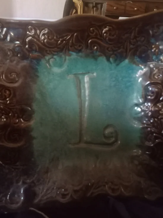 Decorative Ceramic Wall Tile with Turquoise Center and Ornate Brown Border