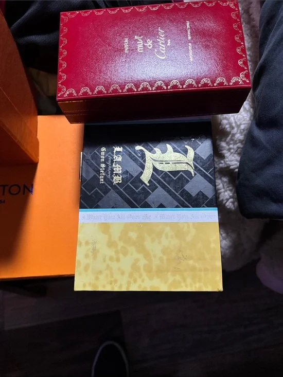 Cartier red and gold jewelry box with decorative trim/L.A.M.B fr by Gwen Stefani