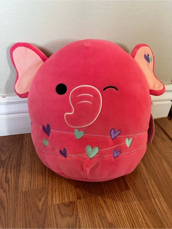 Squishmallows Pink Elephant Pillow with Multicolor Heart Accents.