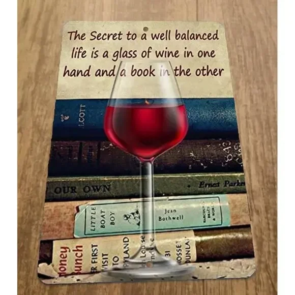 The Secret to a well balanced life is a glass of wine and a book 8x12 Metal Sign
