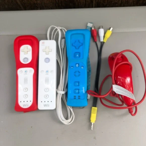 3 Nintendo Wii Remote Plus controllers and a Nunchuk accessory AV Cable