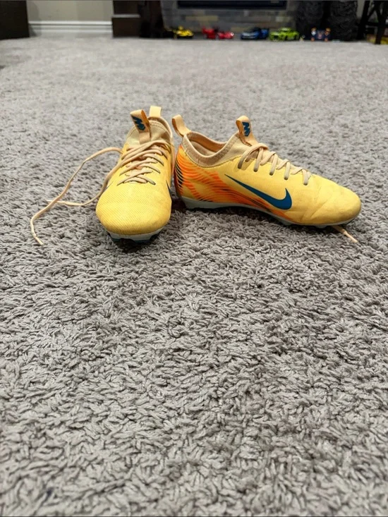 Nike Yellow Soccer Cleats with Blue Swoosh and Orange Accents