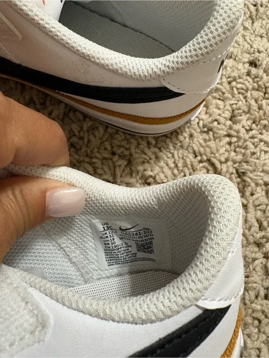 Nike White Sneakers with Black Swoosh and Gold Accent girls size 13 never worn